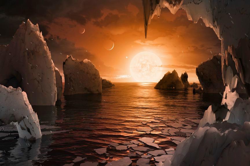 Så här skulle det kunna se ut på en nyupptäckt exoplanet runt stjärnan Trappist-1, enligt Nasas tecknare. Illustration: Nasa/JPL-Caltech via AP/TT