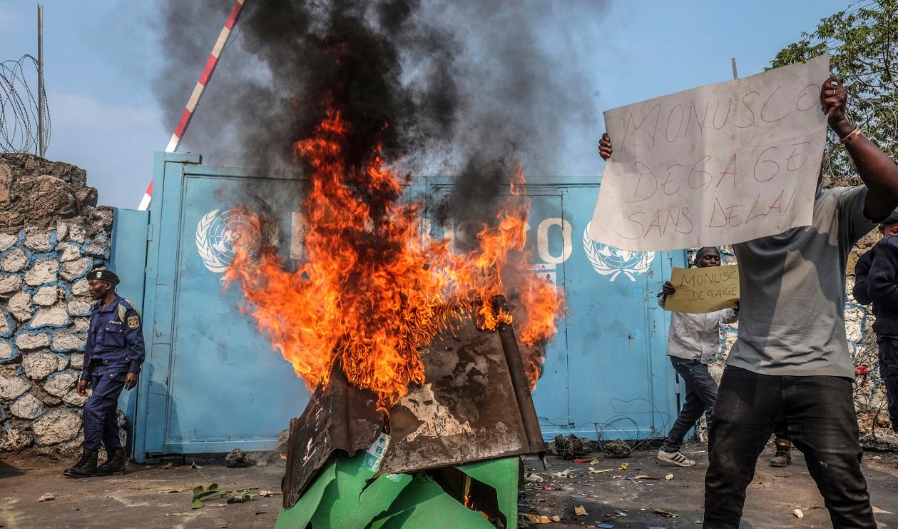 En demonstrant i Kongo-Kinshasa protesterar mot FN:s närvaro och kräver på ett plakat att "Monusco måste lämna omedelbart". Foto: Moses Sawasawa/AP/TT