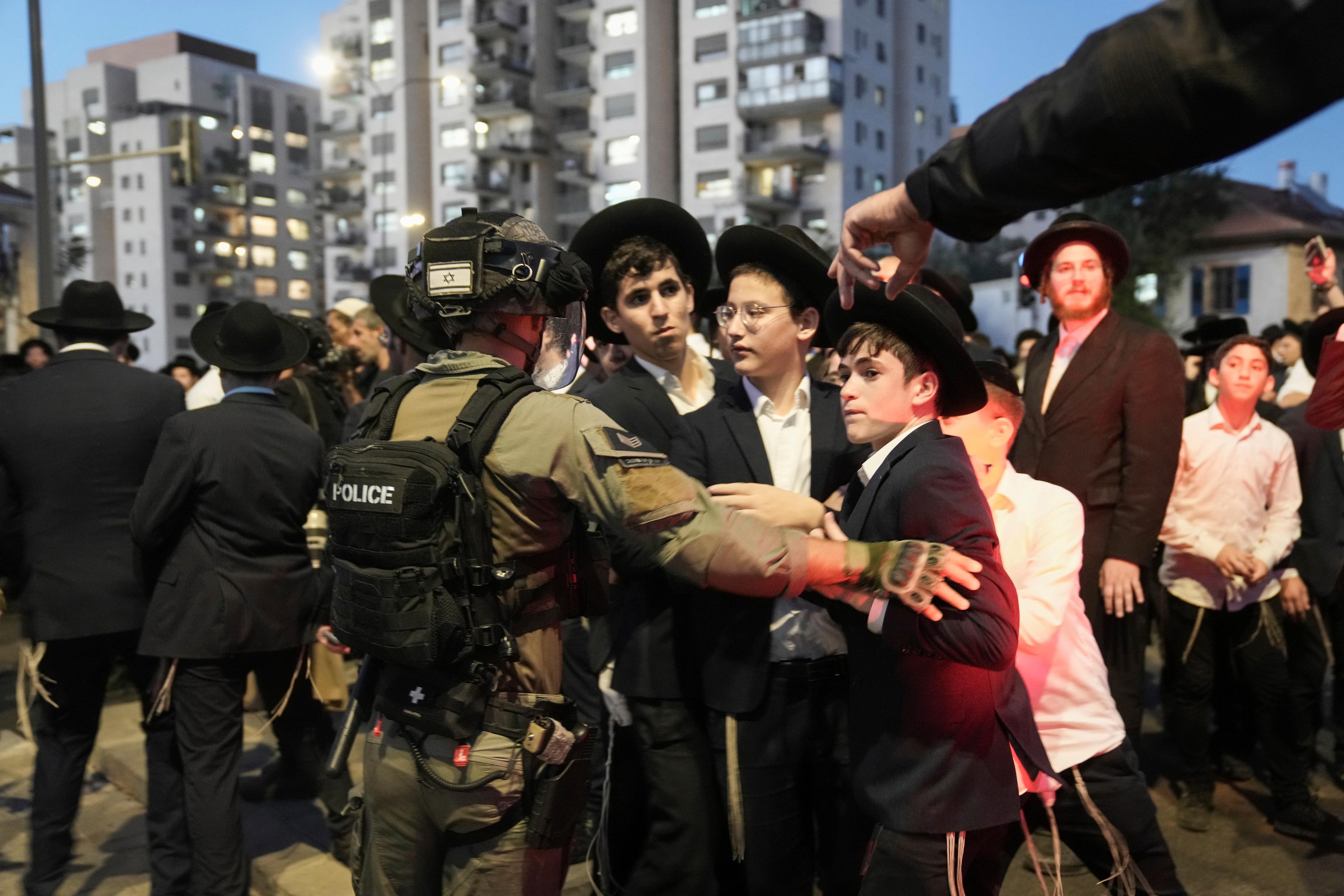 Ultraortodoxa judiska män i sammandrabbning med israelisk polis i protest mot att de ska kallas in till militären. Bild från 30 juni. Foto: Mahmoud Illean/AP/TT