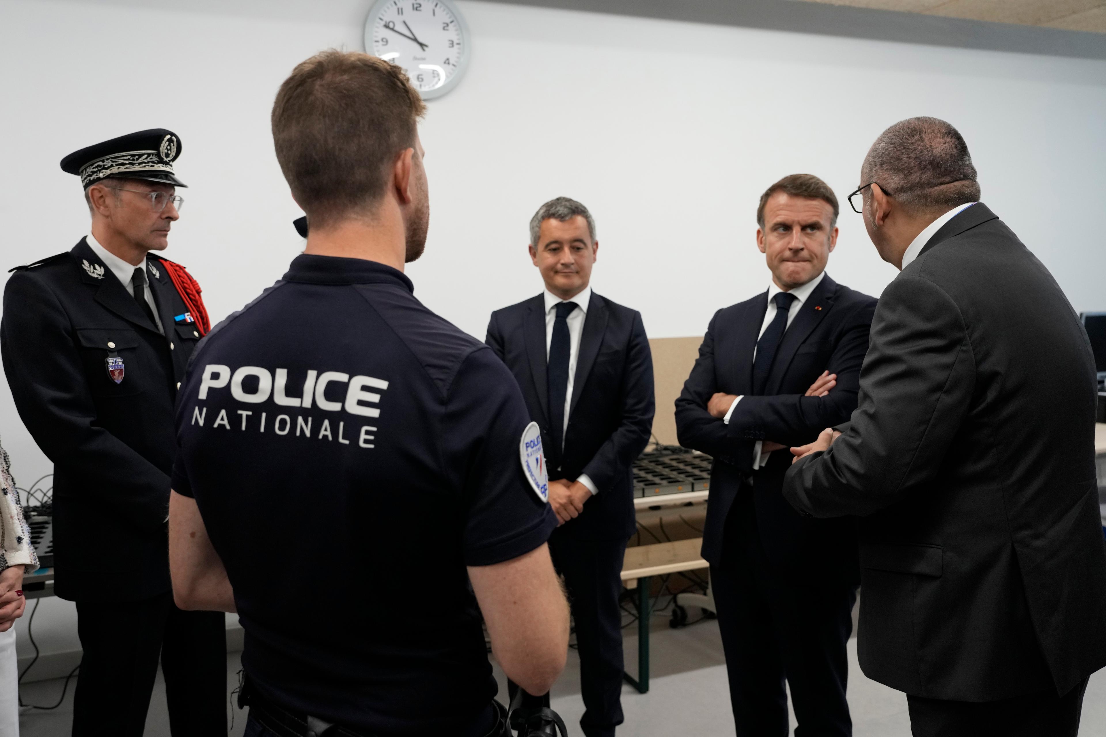 Frankrikes inrikesminister Gerald Darmanin och president Emmanuel Macron besökte en polisstation inför OS i Paris. Foto: Michel Euler/AP/TT