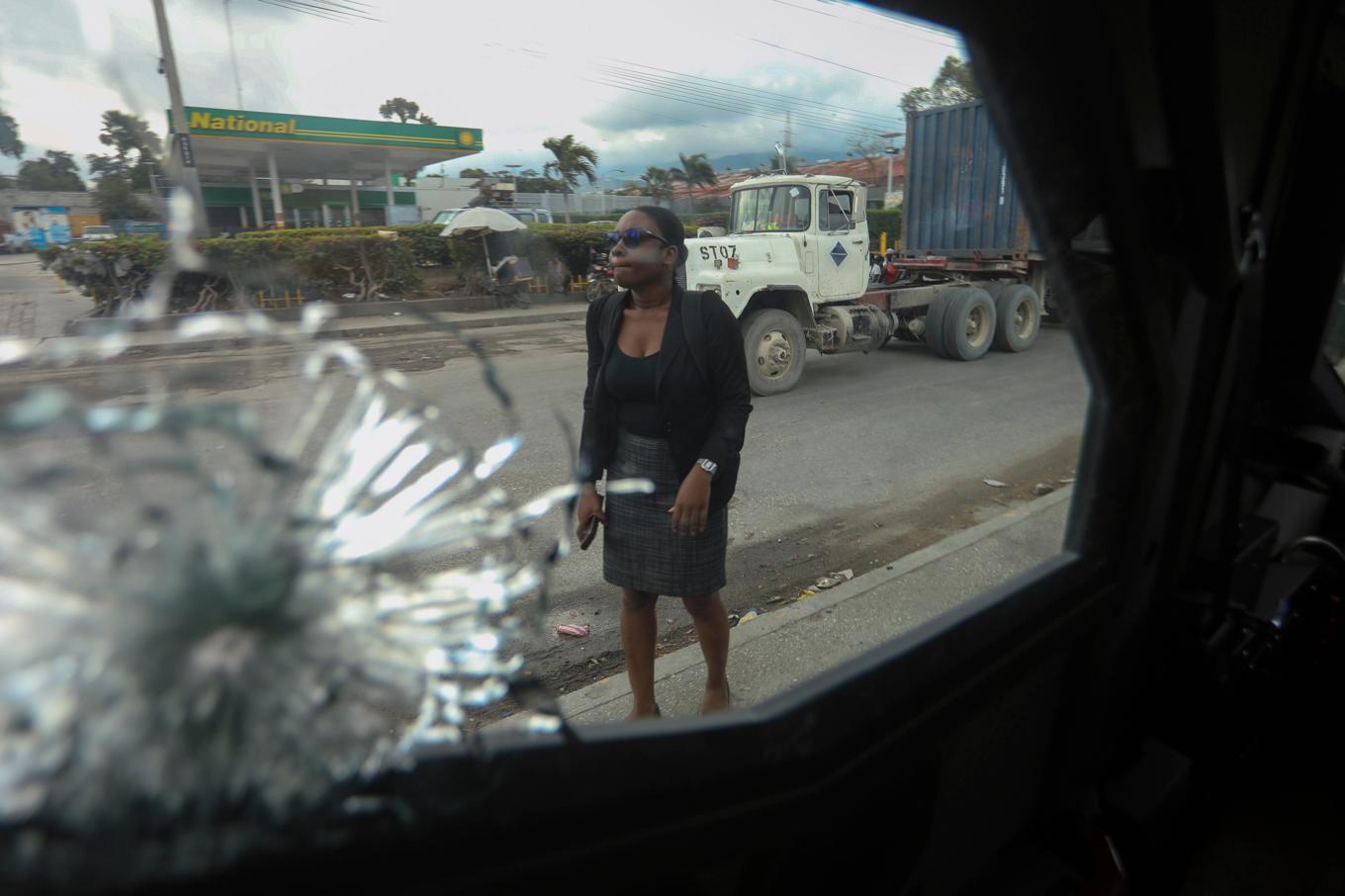 En kvinna går förbi ett skadat fordon i Port-au-Prince. Arkivbild Foto: Odelyn Joseph/AP/TT