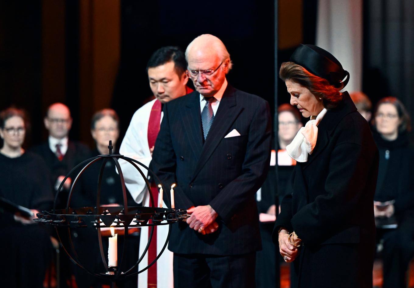 Kung Carl XVI Gustaf och drottning Silvia tände ljus för tsunamikatastrofens offer vid minnesgudstjänsten i Uppsala domkyrka. Foto: Christine Olsson/TT