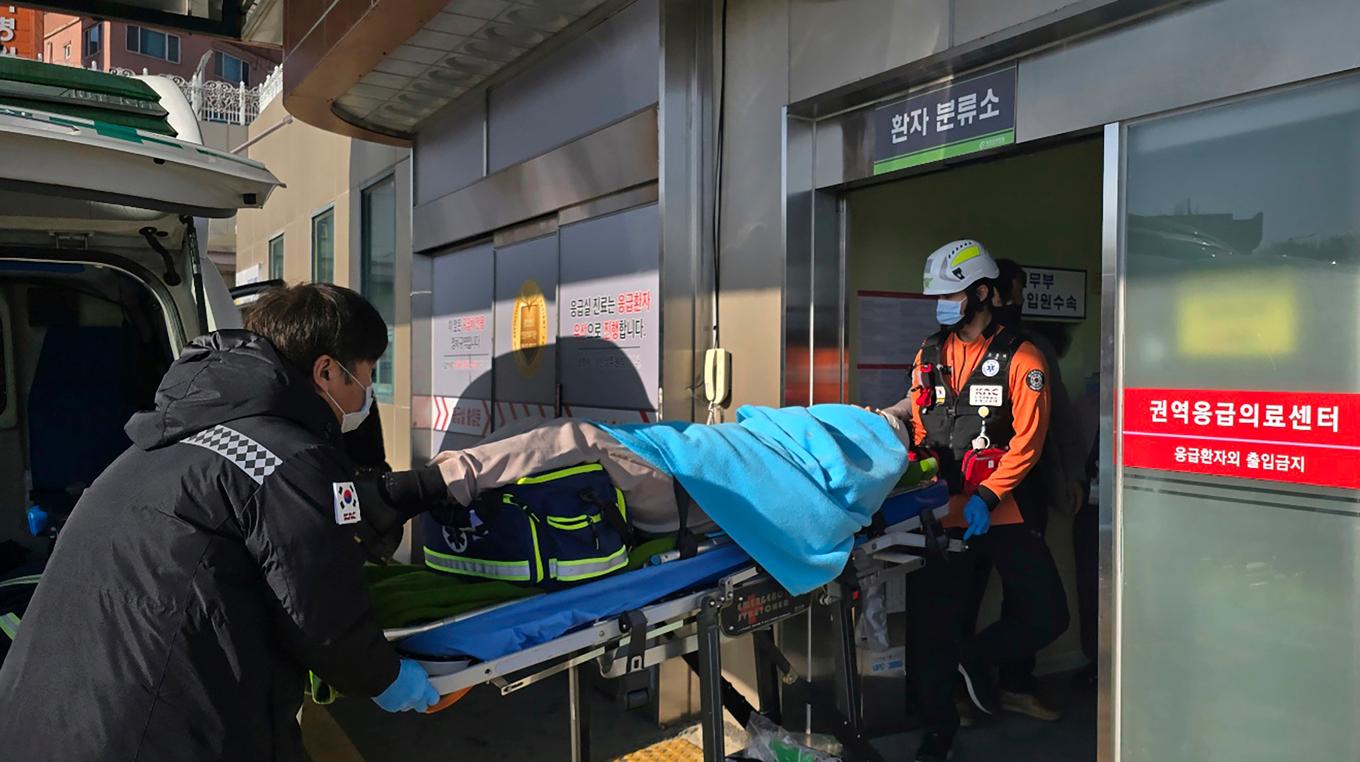 En av överlevarna förs in till sjukhuset efter flygkraschen i Sydkorea. Foto: Cho Geun-young/Yonhap via AP/TT