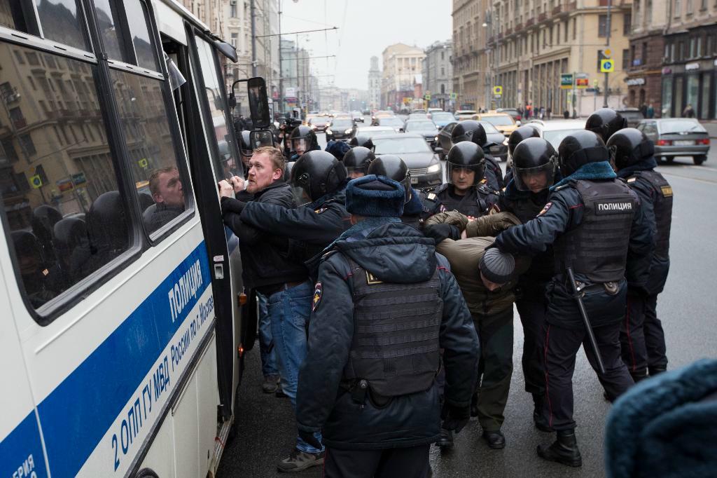 Gripna placerades i en polisbuss för att transporteras bort från Triumftorget, där demonstrationen skulle ha ägt rum. Foto: Pavel Golovkin/AP/TT