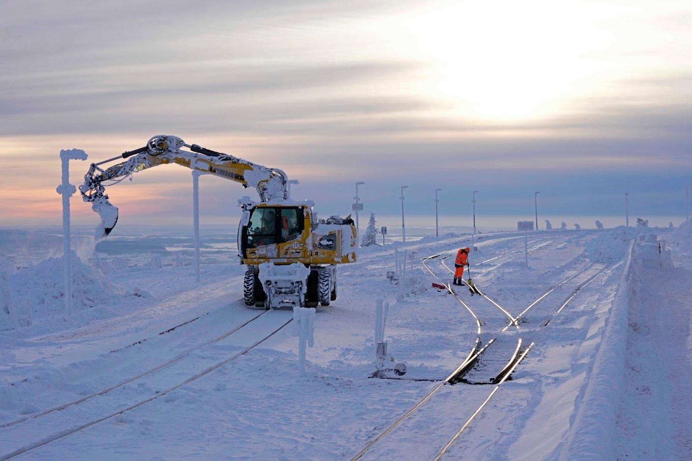 Järnvägsarbetare rensar räls från snö nära Schierke i Tyskland. Foto: Matthias Schrader/AP/TT