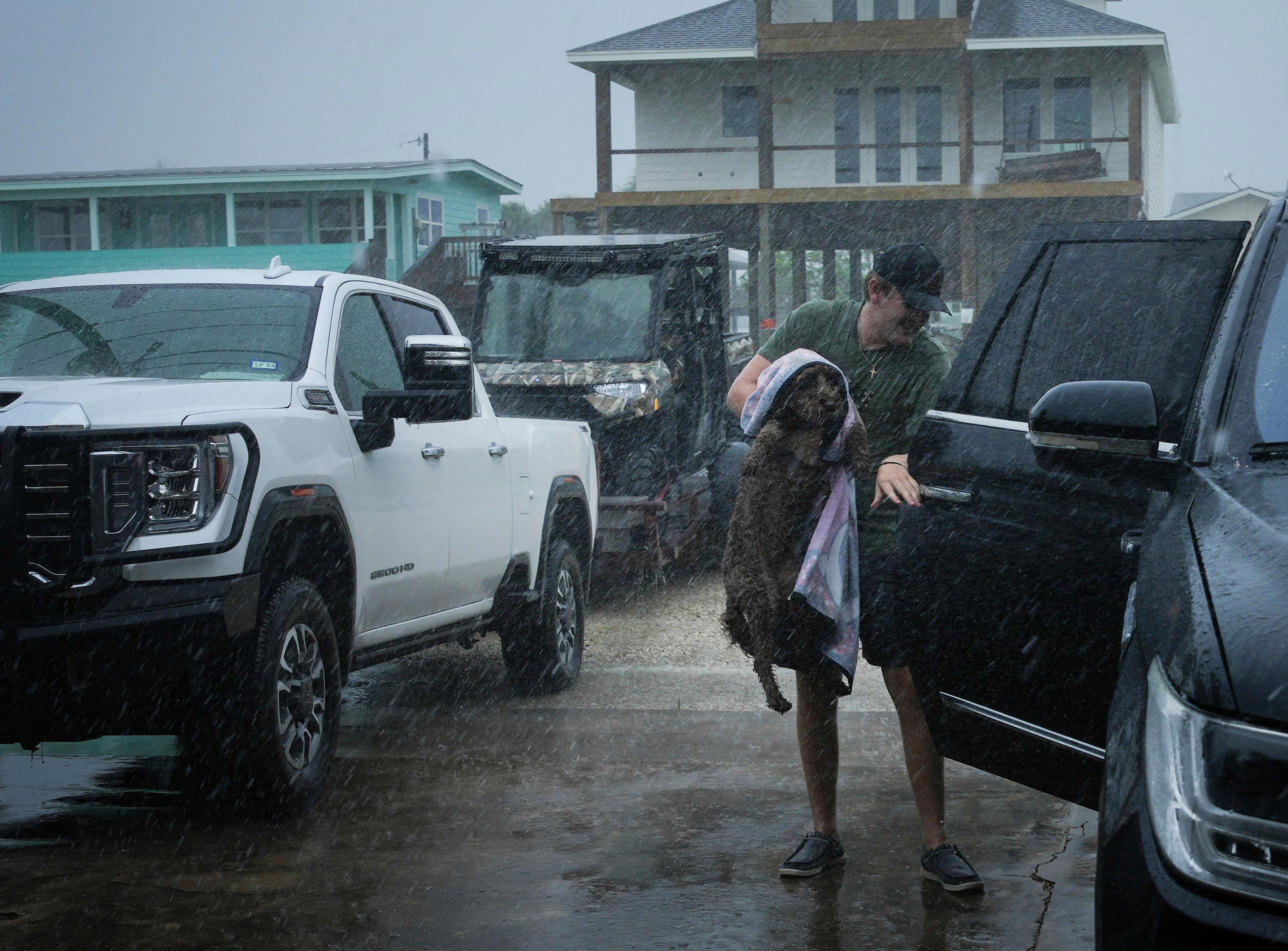 Blake Braun lastar in sin hund Dolly i bilen innan stormens öga träffar Texas kust. Bild från den 7 juli 2024. Foto: Jon Shapley/Houston Chronicle/AP/TT