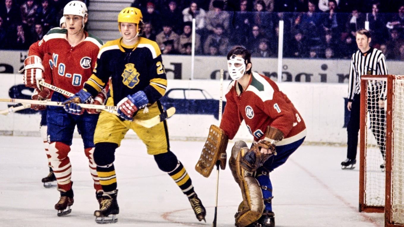 En ung Ulf ”Lill-Pröjsarn” Nilsson mellan MoDo:s Kjell-Rune Milton och målvakten Gunnar Bäckman i SM-serien i januari 1971, på Johanneshovs isstadion i Stockholm. Foto: Jan Collsiöö/TT