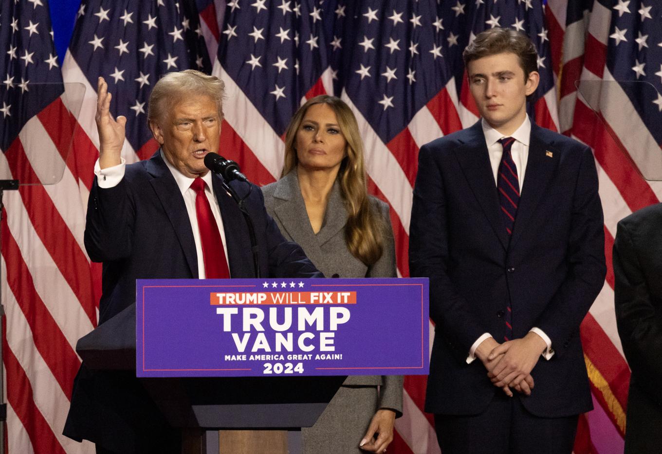 USA:s tillträdande president Donald Trump talar till sina supportrar efter valsegern, West Palm Beach, Florida, den 6 november. Bredvid honom står hustrun Melania och sonen Barron. Foto: John Fredricks