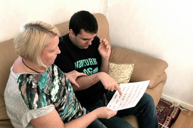 Gunnel och David kommunicerar genom bokstavstavlan. Foto: Privat