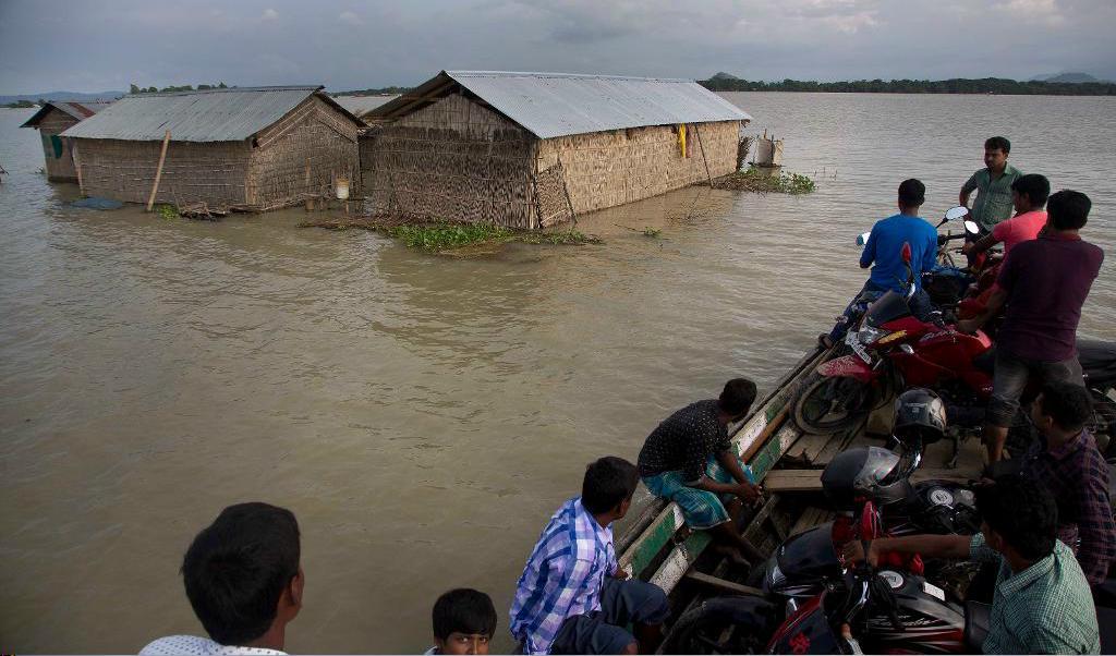 
Människor färdas på båt i Burgaon i delstaten Assam, efter förra veckans kraftiga regn och översvämning som kostat minst 20 personer livet. Foto: Anupham Nath/ AP/ TT                                            
