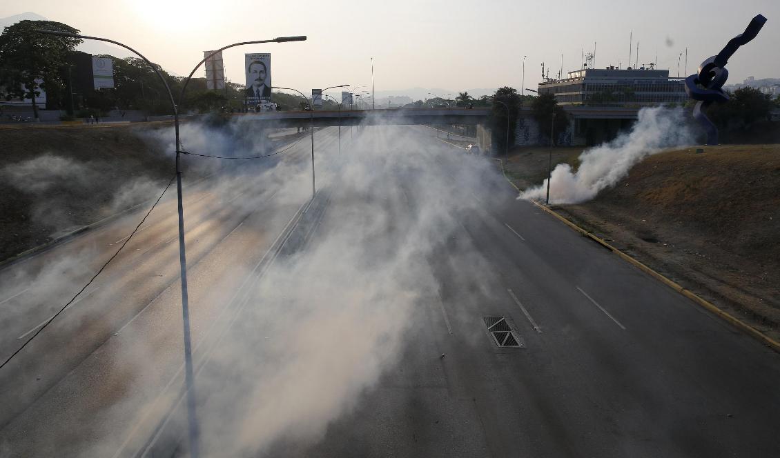 Tårgas har satts in vid den väg som leder till flygbasen där Juan Guaidó talade. Foto: Ariana Cubillos/AP/TT