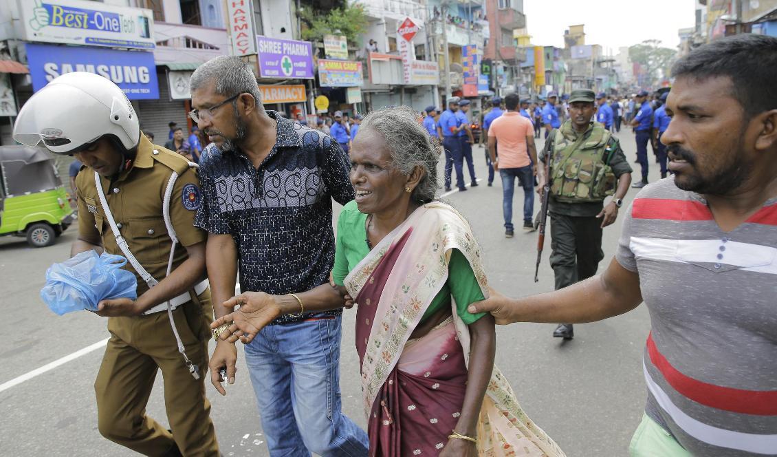 Äldre kvinnor får hjälp efter explosionen i en av kyrkorna i Colombo. Foto: Eranga Jayawardena/AP/TT