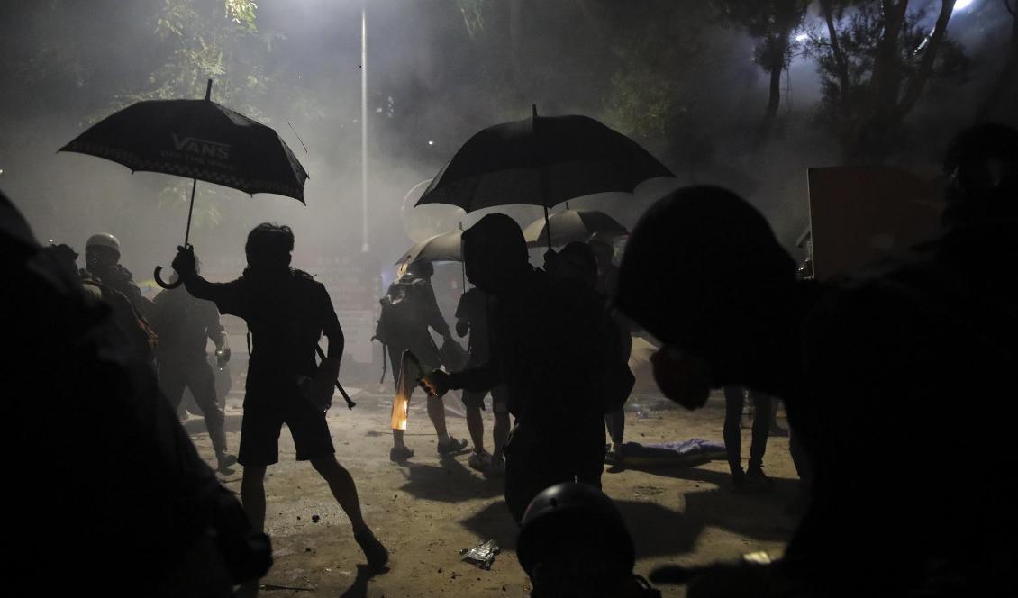Demonstranter förbereder bensinbomber i samband med tisdagens protester. Foto: Kin Cheung/AP/TT