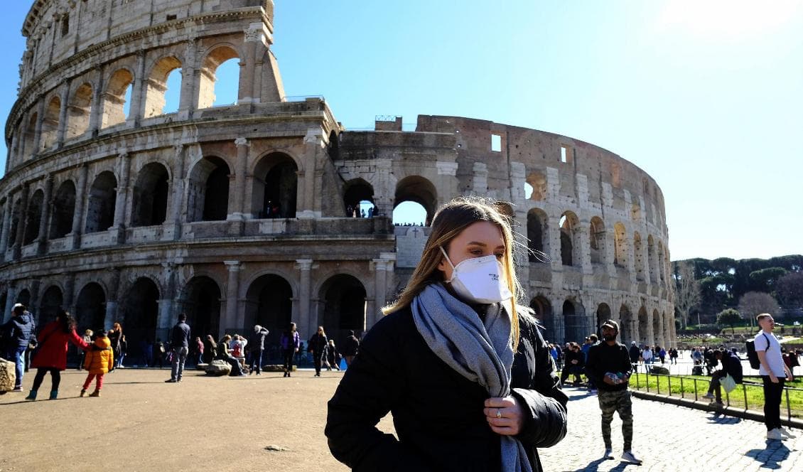 En turist bär en ansiktsmask utanför Colosseum i Rom i Italien den 28 februari 2020. Foto: Andreas Solaro/AFP via Getty Images