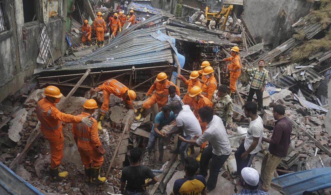 Indiska räddningsarbetare vid den kollapsade byggnaden. Foto: Praful Gangurde/AP/TT
