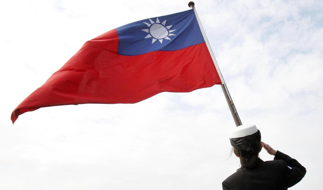 En taiwanesisk officer vid landets flagga. Kina ser Taiwan som en del av sitt territorium och Taiwan har därför endast diplomatiska relationer med ett fåtal länder. Arkivbild. Foto: Chiang Ying-ying/AP/TT