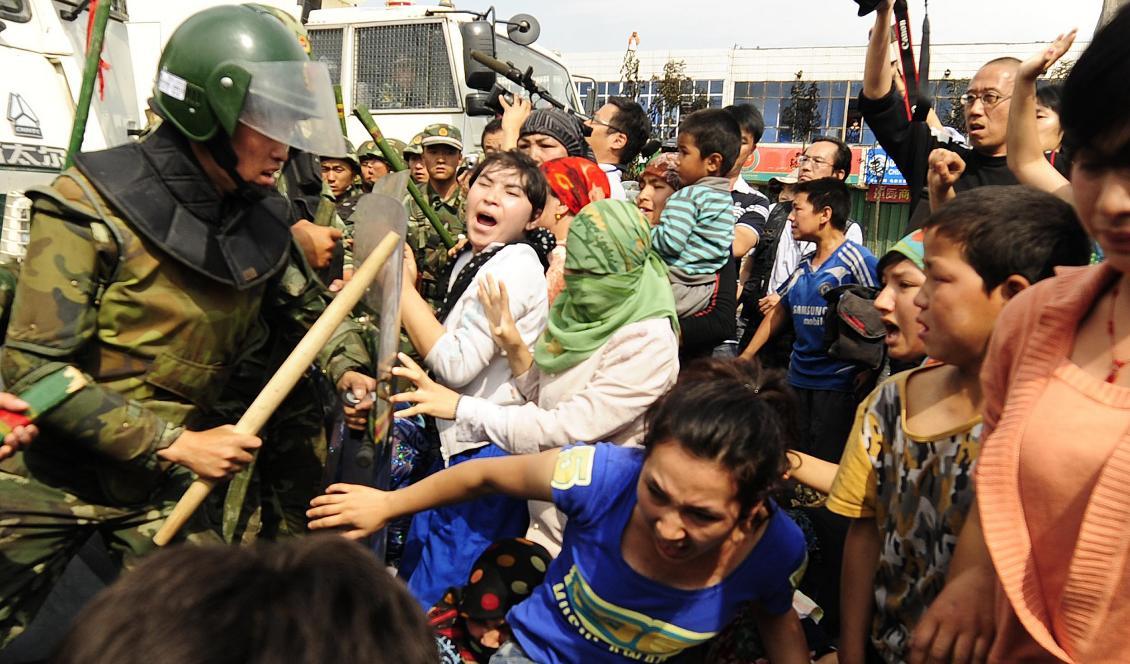 Uigurer i sammandrabbningar med kinesisk kravallpolis i Urumqi i Xinjiang den 7 juli 2009. Foto: Peter Parks/AFP via Getty Images