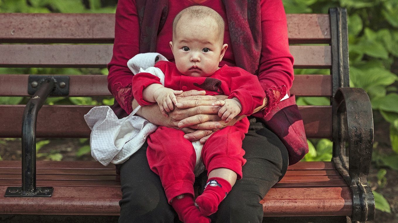 Rika kineser ska ha använt sig av surrogatmödraskap för att få barn som föds som medborgare i USA. Barnet på bilden har inget med artikeln att göra. Foto: Kevin Frayer/Getty Images