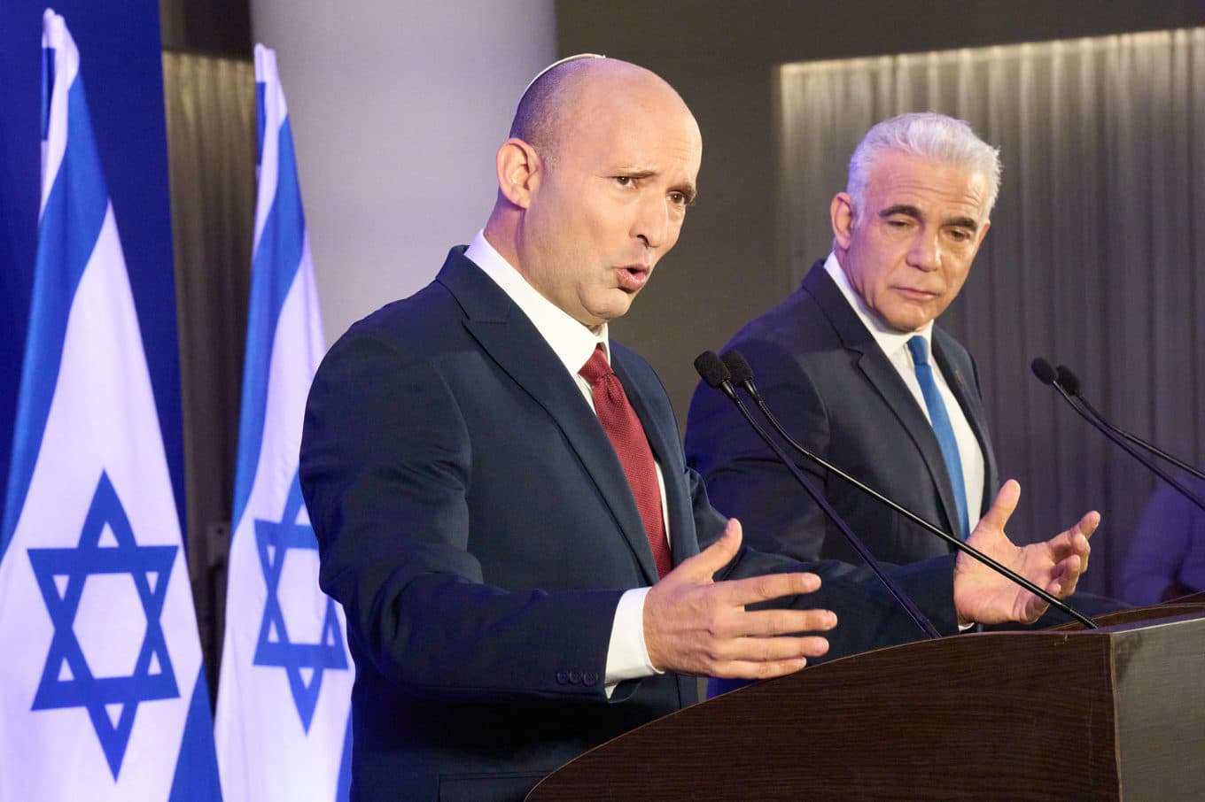 Israels tidigare premiärministrar Naftali Bennett och Yair Lapid tillkännager sin gemensamma valsatsning på en pressträff på söndagen. Foto: Ariel Schalit/AP/TT