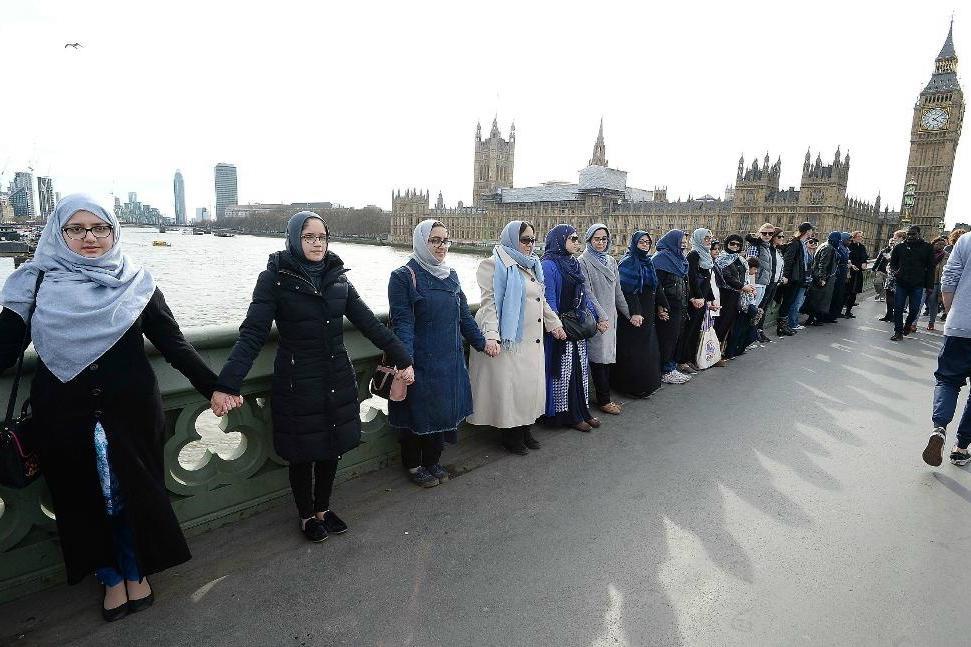 
En grupp kvinnor visar sin solidaritet med offren på Westminster bridge i London. Foto: John Stillwell                                            