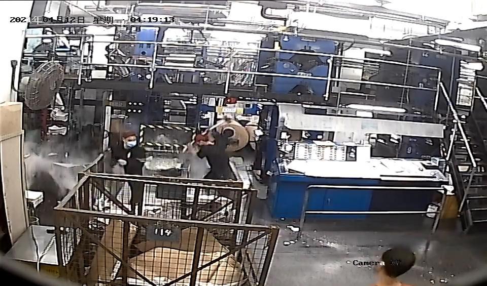 Svartklädda män fångades på övervakningskamera när de slog sönder tryckpressar och annan utrustning på Epoch Times tryckeri i Hongkong den 12 april 2021. Foto: Epoch Times Hongkong