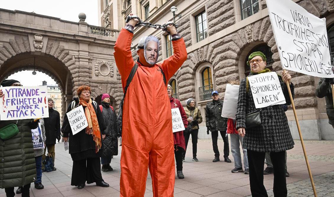 

Demonstranter utanför riksdagen protesterar mot grundlagsändringar om utlandsspioneri som debatteras i riksdagen under onsdagen. Foto: Fredrik Sandberg/TT                                                                                        