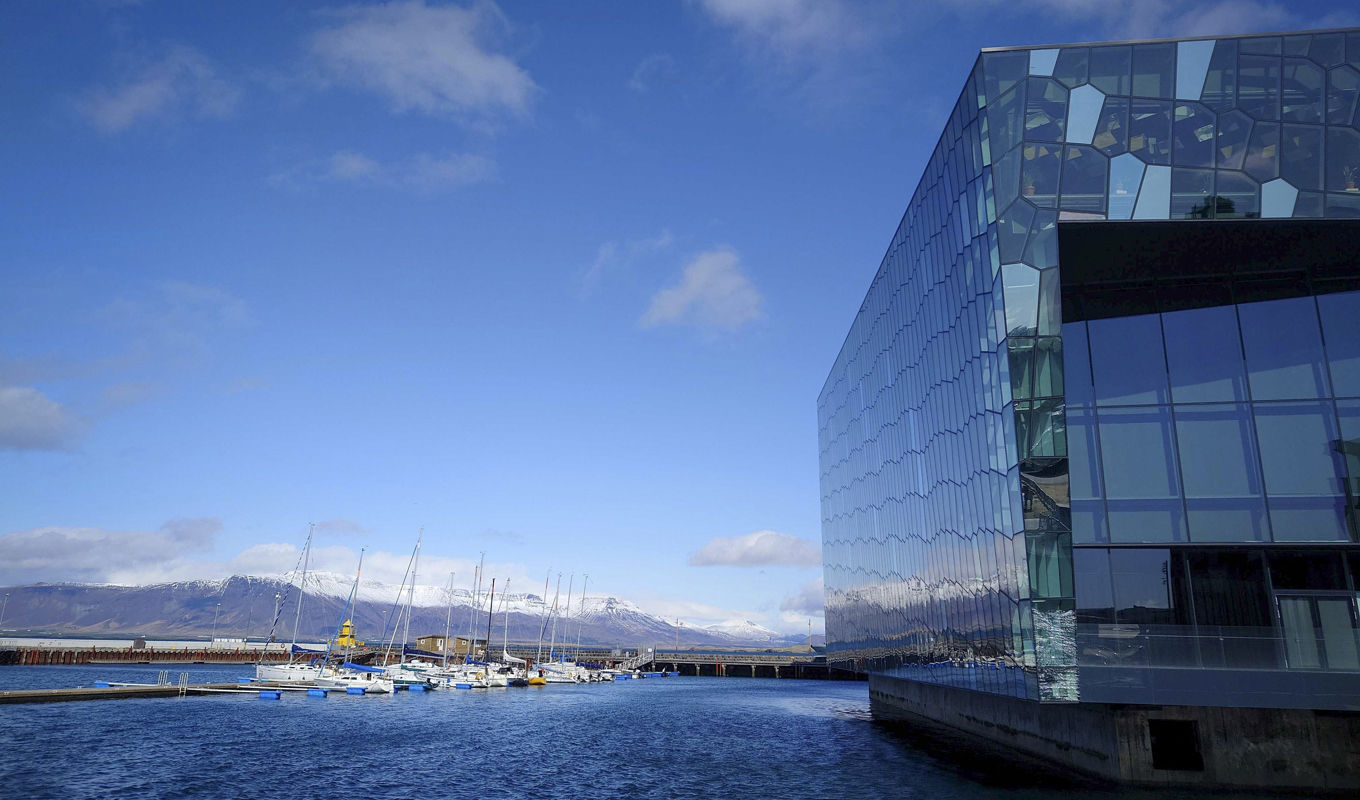 Toppmötesdeltagarna får utsikt över snötäckta fjäll från den pampiga möteslokalen Harpa i centrala Reykjavik. Foto: Henrik Samuelsson/TT
